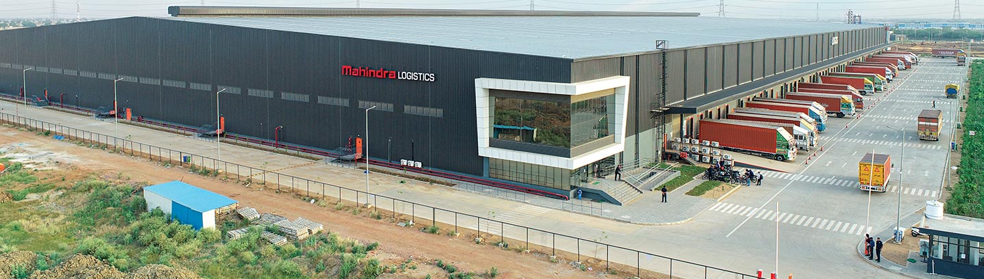 an industrial building featuring a spacious warehouse - Mahindra Logistics